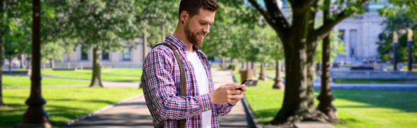 Man looking at cellphone in park