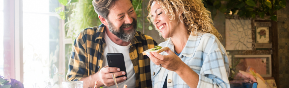 Couple eating lunch on cellphone