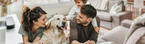 family smiling with dog