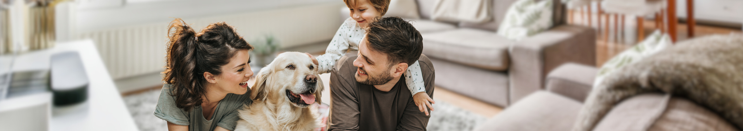 family smiling with dog
