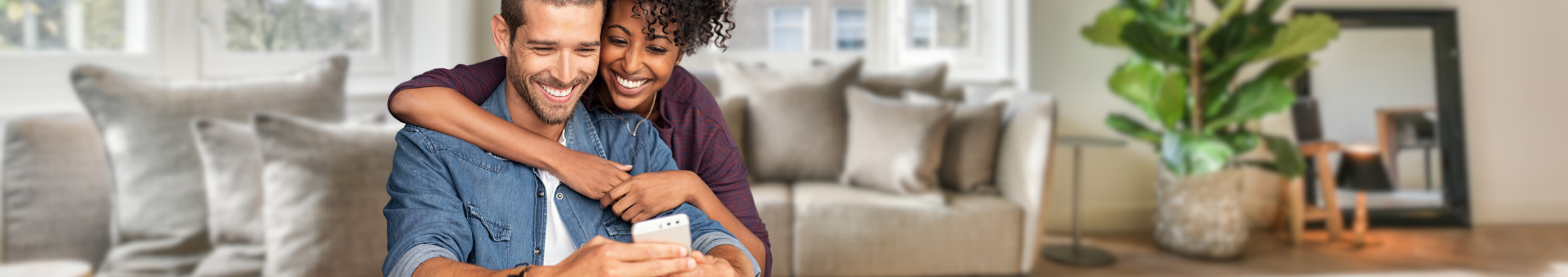 Couple looking at cellphone in living room