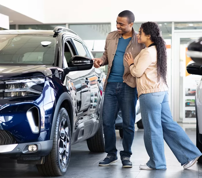 a couple shopping for a new car